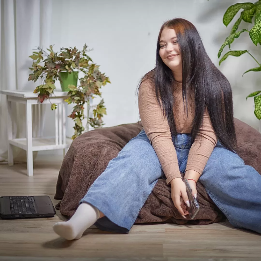 young autistic woman sitting in apartment